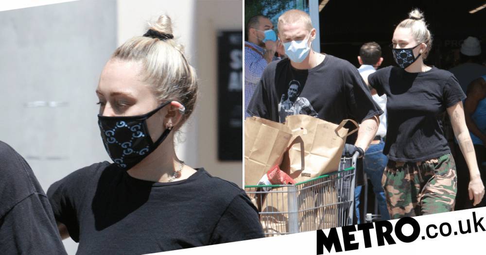 Miley Cyrus emerges from lockdown in face mask with Cody Simpson but keeps self-cut hair tied up - metro.co.uk - Los Angeles - city Cody, county Simpson - county Simpson