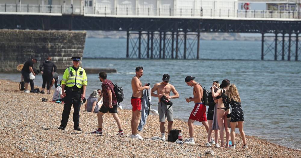 Police see lockdown crumbling as they turn back beachgoers on 200-mile round trip - dailystar.co.uk - city Milton