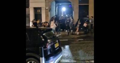 Huge crowd in coronavirus hotspot city 'hug and dance' in street at 10pm sparking fury - mirror.co.uk - Britain - city Newcastle