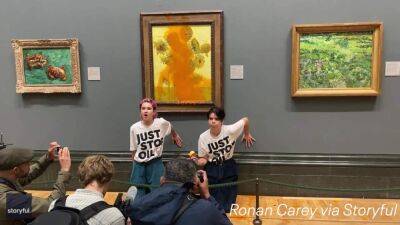 Watch: Climate protesters throw tomato soup on Van Gogh's famous 'Sunflowers' painting - fox29.com - Britain - Netherlands - Syria