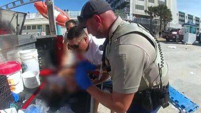 WATCH: New bodycam video shows chaos after car drives across Daytona Beach and into ocean, injuring a child - fox29.com - county Volusia - state Tennessee