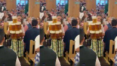 Watch this Oktoberfest server wow the room with her beer-carrying skills - fox29.com - Germany - Spain