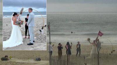 Caught on weather cam: Couple gets married on Cape May beach as severe storms swirl around them - fox29.com - Austria - state New Jersey - Jersey - county Cape May