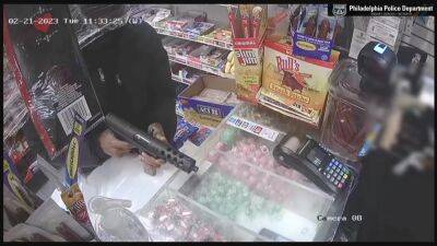 Watch: Suspect brandishes machine gun during West Philadelphia market robbery - fox29.com